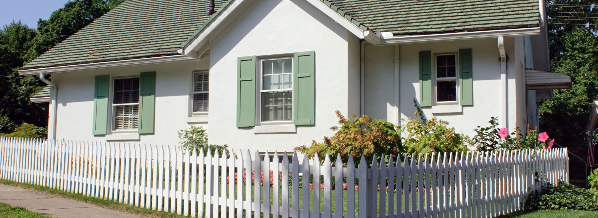 Picket Fence in front of a House